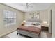 Bright bedroom with window and ceiling fan at 11574 Westwood Blvd # 1112, Orlando, FL 32821
