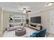 Living room with staged furniture and large TV at 11574 Westwood Blvd # 1112, Orlando, FL 32821