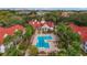 Aerial view of a community pool surrounded by lush greenery and palm trees at 11574 Westwood Blvd # 1112, Orlando, FL 32821