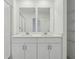 Modern bathroom with double vanity and shower at 16387 Happy Eagle Dr, Clermont, FL 34714