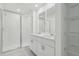 Bathroom with double vanity, shower and shelving at 16387 Happy Eagle Dr, Clermont, FL 34714