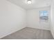 Bright bedroom with gray carpet and window at 16387 Happy Eagle Dr, Clermont, FL 34714