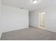 Bright bedroom with grey carpet and ensuite bathroom at 16387 Happy Eagle Dr, Clermont, FL 34714