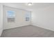 Spacious bedroom with two windows and grey carpet at 16387 Happy Eagle Dr, Clermont, FL 34714