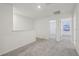Upstairs hallway with gray carpet and access to bedrooms at 16387 Happy Eagle Dr, Clermont, FL 34714