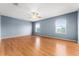 Spacious bedroom with light blue walls and wood floors at 2657 W Dover Glen Cir, Orlando, FL 32828