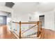 Upstairs hallway with wood floors and bathroom access at 2657 W Dover Glen Cir, Orlando, FL 32828