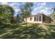 A spacious backyard that features a charming exterior and a lush green lawn at 1989 Marsh Hen Vlg, Deland, FL 32720