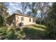 A spacious backyard that features a charming exterior and a lush green lawn at 1989 Marsh Hen Vlg, Deland, FL 32720