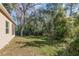 A spacious backyard that features a charming exterior and a lush green lawn at 1989 Marsh Hen Vlg, Deland, FL 32720