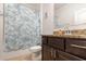 Bright bathroom features granite counters and a modern shower curtain at 1989 Marsh Hen Vlg, Deland, FL 32720