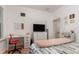 Comfortable bedroom with desk, and a large flat screen TV atop a white chest of drawers at 1989 Marsh Hen Vlg, Deland, FL 32720
