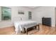 Bright bedroom features wood floors, tray ceiling, and bench seat at the end of the bed at 1989 Marsh Hen Vlg, Deland, FL 32720