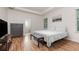 Tranquil bedroom featuring wood floors, a gray dresser, and a view into the ensuite bathroom at 1989 Marsh Hen Vlg, Deland, FL 32720