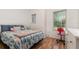 Bedroom with modern decor and a red chair facing a window for natural light at 1989 Marsh Hen Vlg, Deland, FL 32720
