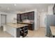 Well-equipped kitchen with granite countertops, stainless steel appliances, and ample dark wood cabinets at 1989 Marsh Hen Vlg, Deland, FL 32720