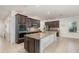 Spacious kitchen featuring granite countertops, stainless steel appliances, and dark wood cabinetry at 1989 Marsh Hen Vlg, Deland, FL 32720