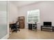 Well-lit home office featuring tile floors, a desk, shelving, and a large window at 1989 Marsh Hen Vlg, Deland, FL 32720