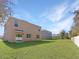 Large backyard with green grass and neighboring houses at 2582 Glacier Express Ln, Tavares, FL 32778