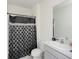 Simple bathroom with shower/tub and gray vanity at 2582 Glacier Express Ln, Tavares, FL 32778
