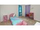 Charming bedroom with pink accents and a twin-sized bed at 2582 Glacier Express Ln, Tavares, FL 32778