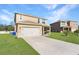 Two-story house with attached garage and spacious yard at 2582 Glacier Express Ln, Tavares, FL 32778