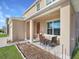 Inviting front porch with seating area, perfect for relaxing outdoors at 2582 Glacier Express Ln, Tavares, FL 32778