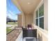 Covered front porch with patio furniture, offering a relaxing outdoor space at 2582 Glacier Express Ln, Tavares, FL 32778