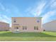 Tan two story house with a grassy backyard at 2582 Glacier Express Ln, Tavares, FL 32778