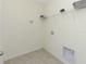 Small laundry room with shelving and hookups at 2582 Glacier Express Ln, Tavares, FL 32778