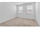 Bright bedroom with neutral carpeting and two windows at 340 Belmond Dr, Debary, FL 32713