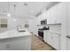 Bright kitchen featuring white cabinets, quartz countertops, and stainless steel appliances at 340 Belmond Dr, Debary, FL 32713