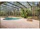 Relaxing backyard featuring screened pool with a brick fire pit and plenty of patio space at 943 Elm Harbor Ct, Lake Mary, FL 32746