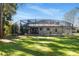 Large backyard featuring lush green grass and a screened-in pool enclosure at 943 Elm Harbor Ct, Lake Mary, FL 32746