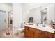 Well-lit bathroom featuring a walk-in shower and a wooden vanity at 943 Elm Harbor Ct, Lake Mary, FL 32746