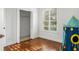 Neutral bedroom showcasing wood floors, closet, and window with shutters at 943 Elm Harbor Ct, Lake Mary, FL 32746