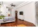 Spacious bedroom featuring hardwood floors, a ceiling fan, and a classic grandfather clock at 943 Elm Harbor Ct, Lake Mary, FL 32746
