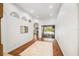 Bright foyer with hardwood floors, arched doorways, and a seamless transition to the outdoor patio at 943 Elm Harbor Ct, Lake Mary, FL 32746