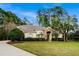 Spacious one-story home with a sprawling lawn, mature landscaping, and a welcoming stone entrance at 943 Elm Harbor Ct, Lake Mary, FL 32746