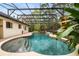 Screened-in pool area with waterfall feature and lush landscaping at 943 Elm Harbor Ct, Lake Mary, FL 32746