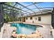 Beautiful screened pool with brickwork and an attached spa in backyard at 943 Elm Harbor Ct, Lake Mary, FL 32746
