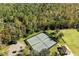 Aerial view of the tennis courts, parking lot, and restroom building surrounded by trees at 943 Elm Harbor Ct, Lake Mary, FL 32746