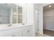 Bright bathroom boasts double sinks, large mirrors, and a walk-in closet at 5166 Minneola Ln, Saint Cloud, FL 34772