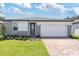 One-story home with gray stone accents and a two-car garage at 5166 Minneola Ln, Saint Cloud, FL 34772