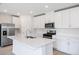 Modern kitchen with white cabinets and island at 5166 Minneola Ln, Saint Cloud, FL 34772