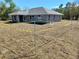 New construction home featuring gray stucco and roof and an ample yard awaiting a future garage to be installed at 8749 Se 159Th Ln, Summerfield, FL 34491
