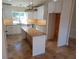 Well-lit kitchen featuring an island, stainless steel appliances, granite countertops, and white cabinets at 8749 Se 159Th Ln, Summerfield, FL 34491