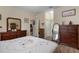 Cozy bedroom with hardwood floors, dressers, and a large floral quilt at 5307 Cortland Dr, Davenport, FL 33837