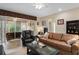 Inviting living room with a plush leather sofa, comfortable seating, and a sliding glass door to the screened lanai at 5307 Cortland Dr, Davenport, FL 33837