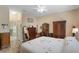 Serene main bedroom featuring wood-look floors, a traditional dresser, and a view into the en-suite bathroom at 5307 Cortland Dr, Davenport, FL 33837